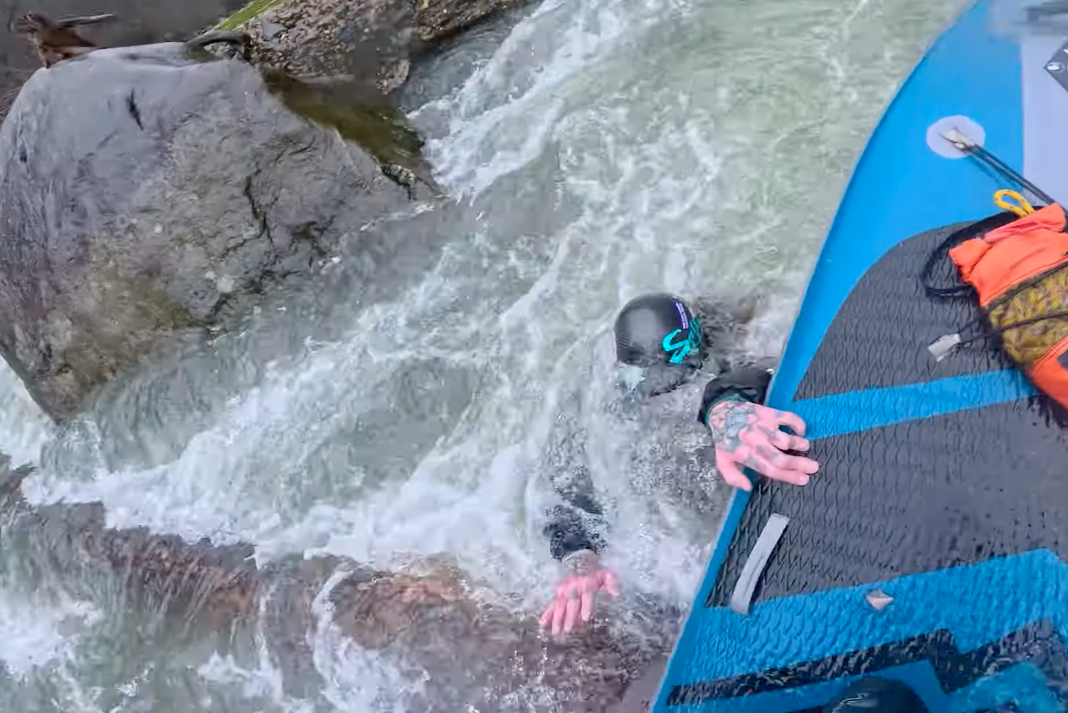 Standup paddleboarder saves kayaker with bold rescue.